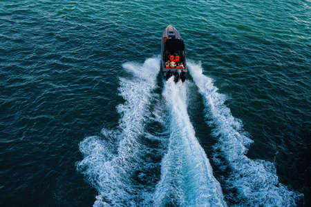 Tourists on excursions along the ocean in a boat. Beautiful yacht for walking on the water.の写真素材