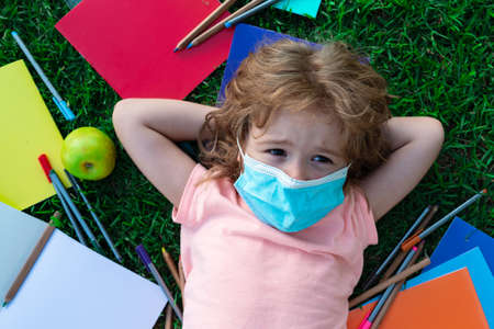 Schoolchildren in masks during quarantine. Distance Learning.の写真素材