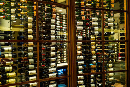 Wine collection. Beautiful bottles of expensive wines in the showcase of the restaurant and casino.の写真素材