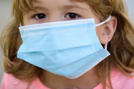 Childrens face in a medical mask. Protection against coronavirus, infectious disease, quarantine. Pandemic and children.の写真素材