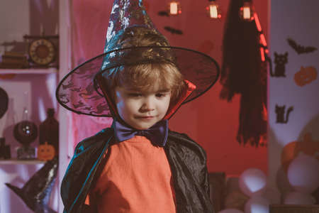 A modest shy child. Little wizard for Halloween. Child in costume for Halloween party. Beautiful preschooler asks for sweets.の写真素材