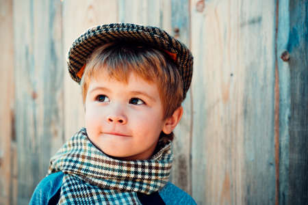 Beautiful kid boy on a wooden background.の写真素材