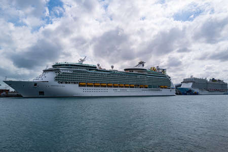 MIAMI, FLORIDA, USA - MAY, 2020: White cruise ship docked at the port of Miami. Large luxury cruise ship on sea water docked at port of Miami.の写真素材