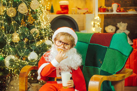 Santa Claus enjoying in served gingerbread man cake and milk. Christmas cookies. Cookies for child Santa Claus. Milk and cookies for Santa Claus. Christmas cookies. Merry Christmas.の写真素材
