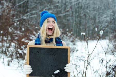 Happy girl with winter sale advertisement.の写真素材