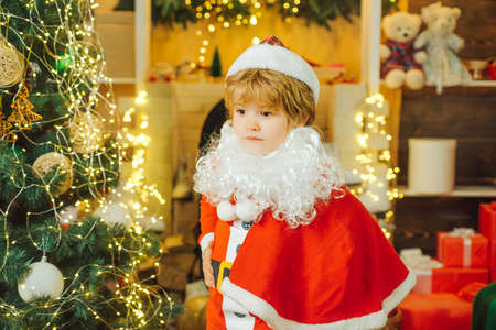 Child Santa Clause and Christmas tree.の写真素材