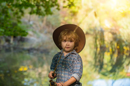 Quarantine. Fishing alone. Sad boy catches a fish.の写真素材
