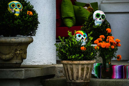 Vases with skulls near the house. Scenery for Halloween in October. Decoration in the yard.