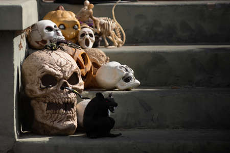 Disgusting skulls on the stairs of the house. Scenery for Halloween in October. Decoration in the yard.の写真素材