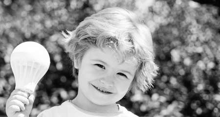 Idea. Happy child with a light bulb. The concept of a successful idea.の写真素材