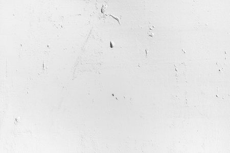 White wall of porous material. Holes and cracks. Texture of old white concrete wall for background.の写真素材