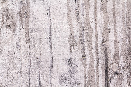 Concrete texture background. Wall with cement and concrete. Visible smudges and dirty surface. Many hollows and roughness.の写真素材