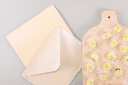 Greeting card for your text. Flat lay, top view photo mock up. Yellow flowers on gray background.の写真素材