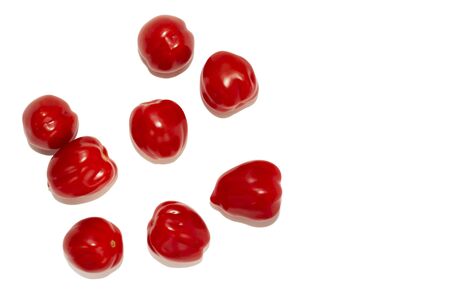 So-called elongated tomatoes, laid one near the other, isolated on a white background. Lots of red small uncut elongated cherry tomatoes top view. Space for text. Stock image, San Marzano Lampadinaの写真素材