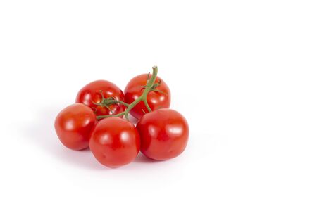 Fresh tomatoes on branch isolated on white. Branch of delicious five tomatoes on the left. Stock photo, side view. Ingredients for cooking. Healthy food, vegetables, vegetarian culture.の写真素材