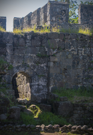abstract ruins of a defensive wall from a old stone. fragment of architecture of an ancient...