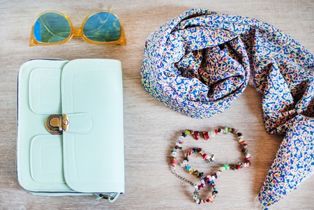 Fashionable photo bright handbag, scarf, big retro glasses, colorful beadsの写真素材