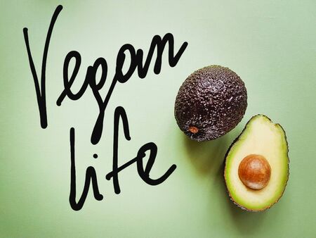 Hass avocado on a green background. Vegan life. Healthy food. Food green.