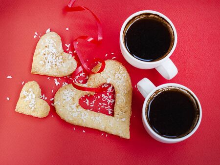 Two cups of coffee on red background, love, valentine day, strong coffee - strong love family, dating romance, relationship anniversary, sweet couple, in love, reciprocity, lovers, happy valentines dayの写真素材