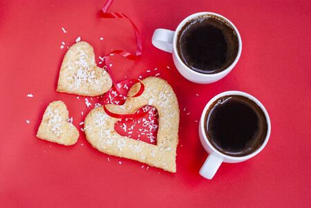 Two cups of coffee on red background, love, valentine day, strong coffee - strong love family, dating romance, relationship anniversary, sweet couple, in love, reciprocity, lovers, happy valentines dayの写真素材