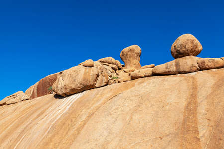 Round rocks on large rock at Spitzkoppe Namibiaの写真素材