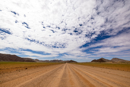 Wide gravel road in Namib Naukluft NP Namibiaの写真素材