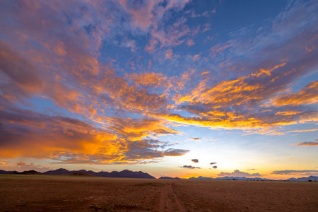Pink and orange colored clouds after sunset Namibiaの写真素材