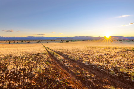 The sun rise over the Tiras Mountains at Namibrand Nature Reserve Namibia