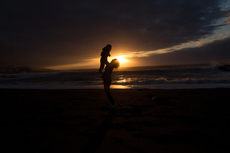 Mother and Child - Family silhouette Sunset -Beachの写真素材