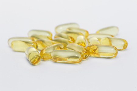 Vitamin C pills fish oil omega 3 gel capsules isolated on white background