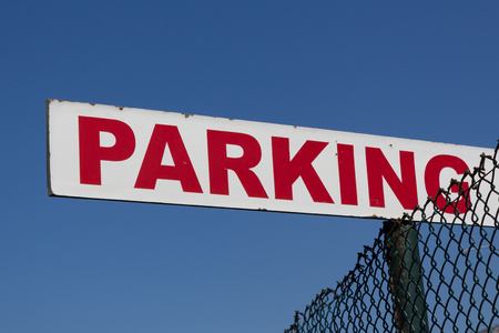 red parking sign on blue sky - parking placeの写真素材