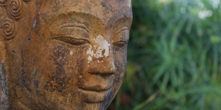 buddhist statue in nature - garden decorationの写真素材