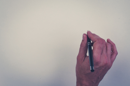 hand holding pen isolated over white background - hand holding pencil on white paperの写真素材