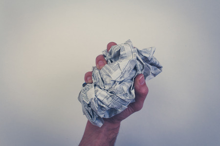 hand fist holding screwed newspaper, German business sectionの写真素材