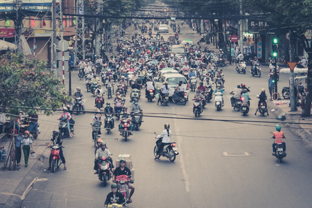 Saigon, Vietnam, January 17. 2014: Road traffic crowded with motorbikes and scooter drivers. Scooters are the most favorite vehicles in saigon.のeditorial素材