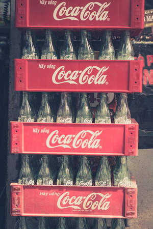 Phnom Penh, Cambodia, January 17, 2014: Empty bottles of Coca Cola in red plastic box - vintage style. Based on Interbrands best global brand study of 2011, Coca-Cola was the worlds most valuable brand.のeditorial素材