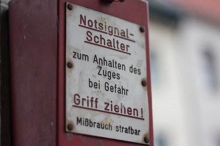 Berlin, Germany - march 30, 2016:  Closeup of an emergency brake at metro station with german text  saying: Pull handle to stop the train.のeditorial素材