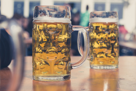 two beer glasses in German beer gardenの写真素材