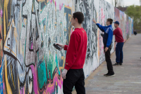 Berlin, Germany - april 8, 2016: People spraying graffiti on wall in Berlin Mauerpark. The Mauerpark is a former part of the Berlin Wall death strip.のeditorial素材