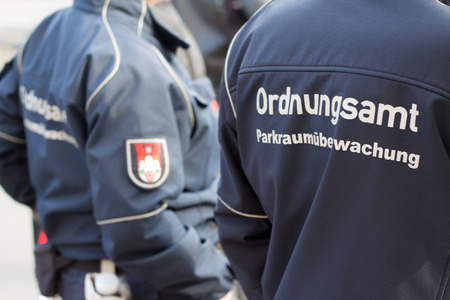 Berlin, Germany - April 8, 2016: The back of a German public order officer / park (security) service man with the German label: "Ordnungsamt ParkraumÃÂ¼berwachung"のeditorial素材