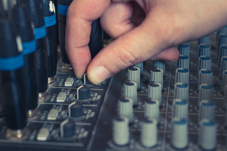 hand on music mixer - studio equipment macro