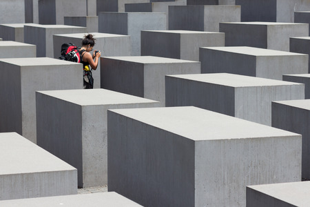 Female traveler at the Memorial to the Murdered Jews of Europe, also known as the Holocaust Memorial in Berlin.のeditorial素材
