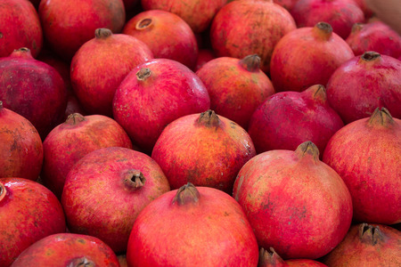 pomegranate, grenadine fruit - pile of pomegranatesの写真素材