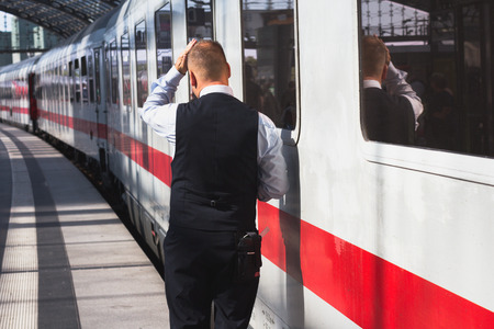 Berlin, Germany - September 9, 2016: Train conductor from behind standing in front of ice train at central staion in Berlin.のeditorial素材