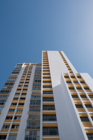white building on blue sky - apartment building facadeの写真素材