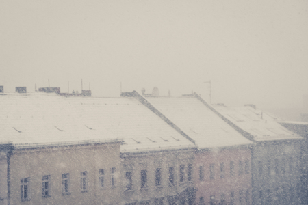 winter panorama, snowing on city skyline - vintage lookの写真素材