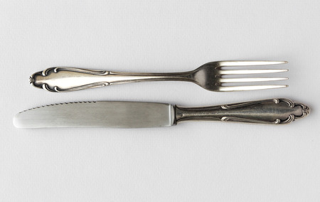 beautiful silver knife and fork isolated on white backgroundの写真素材