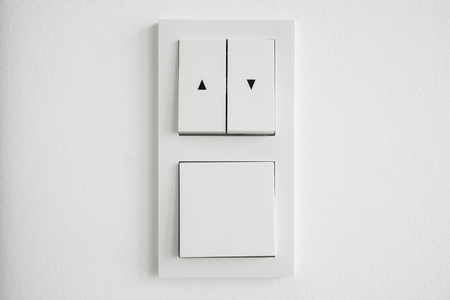 light switch, up down switch closeup on white wall