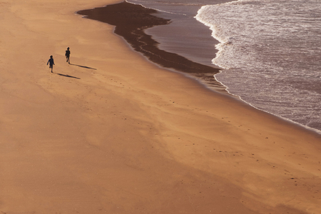 two kids running at beach - children playing at beachの写真素材