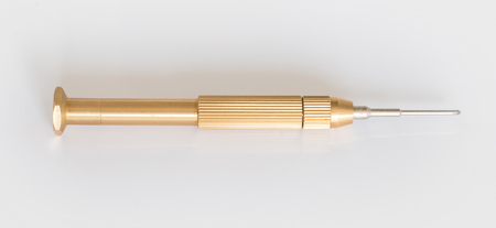 golden mini screw driver isolated - metal screwdriverの写真素材